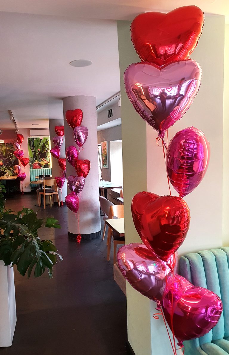 Balony z helem w bukietach jako walentynkowa dekoracja restauracji