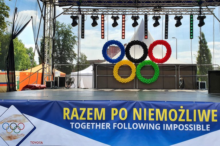 Koła olimpijskie zrobione z balonów jako dekoracje sceny